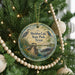 A round ornament hanging on a Christmas tree, featuring a scenic image of Sheldon Lake State Park, Texas.