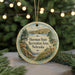 A round ornament with a scenic landscape of a lake, mountains, and trees, featuring a deer in the foreground.