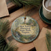 A round ornament with a scenic image of Shot Tower Historical State Park, Virginia, hanging on a wooden surface.
