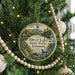 A round ornament hanging on a Christmas tree, featuring a scenic image of Silver Lake State Park in Vermont.