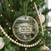 A round ornament hanging on a Christmas tree, featuring a scenic image of Singletary Lake State Park in North Carolina.