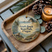 A wooden tray with a decorative ornament featuring a scenic landscape of South Beach State Park, Oregon, along with pine cones and a lit candle.