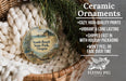 Ceramic ornaments, featuring a scenic image of South Beach State Park, Oregon, are displayed in a woven basket.