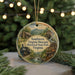 A decorative ornament featuring a scenic image of a historical state park, with a train and other elements, hanging from a string.