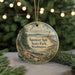 A round ornament with a scenic landscape featuring a lighthouse, beach, and trees, with the text "Spenser Spit State Park, Washington" displayed on it.
