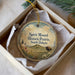 A decorative ornament in a white box, featuring a landscape with a bison and a mountain in the background, along with the text "Spirit Mound Historic Prairie, South Dakota".