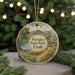 A round ornament with a scenic landscape of Steiner State Park, Utah, featuring a mountain, lake, and cabin.