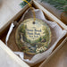A decorative ornament in a box, featuring a scenic image of Stony Brook State Park in New York.