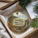 A decorative ornament with the text "Talimena State Park, Oklahoma" printed on it, surrounded by a scenic landscape of mountains, trees, and a waterfall.