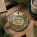 A decorative ornament featuring a scenic landscape of Talimena State Park, Oklahoma, with pine trees and a waterfall.