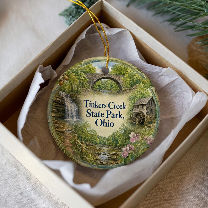 A decorative ornament in a box, featuring a scenic image of Tinkers Creek State Park, Ohio.