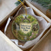 A decorative ornament in a box, featuring a scenic image of Tinkers Creek State Park, Ohio.