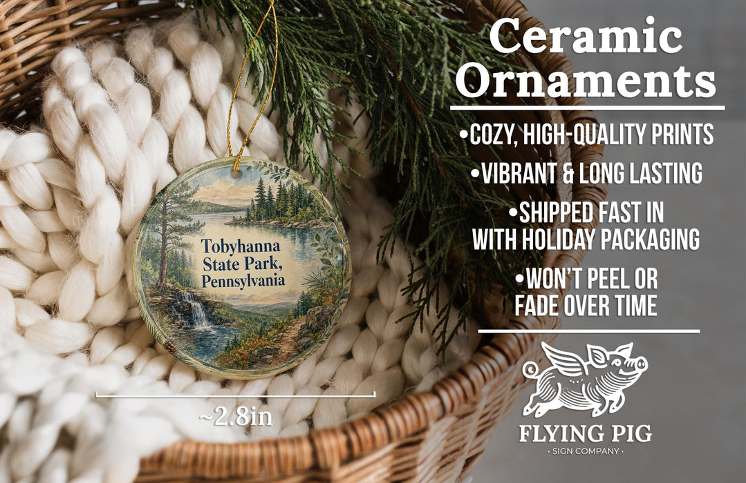 Ceramic ornaments, featuring a scenic image of Tobyhanna State Park, Pennsylvania, hanging from a wicker basket.