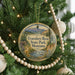 A round ornament hanging on a Christmas tree, featuring a scenic image of Travelers' Rest State Park, Montana.