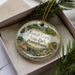 A decorative ornament with a scenic image of the Tough Creek State Park in Pennsylvania, featuring a bird, a waterfall, and a path.