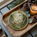 A wooden tray with a decorative ornament featuring a forest scene and the text "Tryon Creek State Natural Area, Oregon" on it.