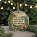 A round ornament with a scenic image of Tu-Endie-Wei State Park, West Virginia, hanging from a string.
