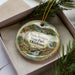 A decorative ornament with a scenic image of Twin Bridges State Park in Oklahoma, featuring a waterfall and a bird in flight.