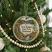 A round ornament hanging on a Christmas tree, featuring a scenic image of Twin Bridges State Park in Oklahoma.