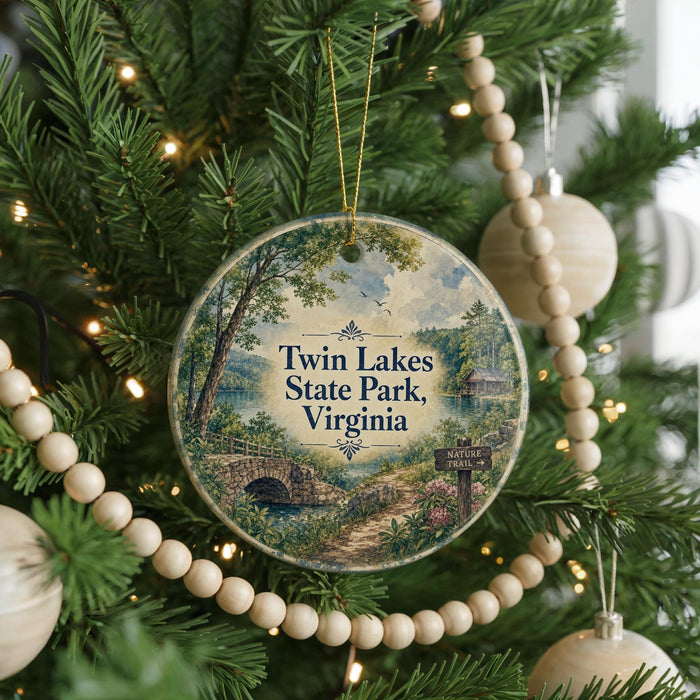 A round ornament hanging on a Christmas tree, featuring a scenic image of Twin Lakes State Park, Virginia.