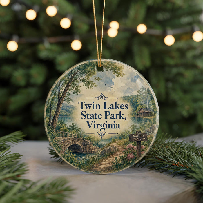 A round ornament with a scenic landscape of Twin Lakes State Park, Virginia, featuring a bridge, trees, and a path.