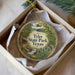 A decorative ornament in a box, featuring a scenic landscape with a waterfall and trees, with the text " Tyler State Park, Texas" prominently displayed.