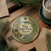 A decorative ornament with the text " Tyler State Park, Texas" on it, surrounded by pine branches and a cup of coffee on a wooden surface.