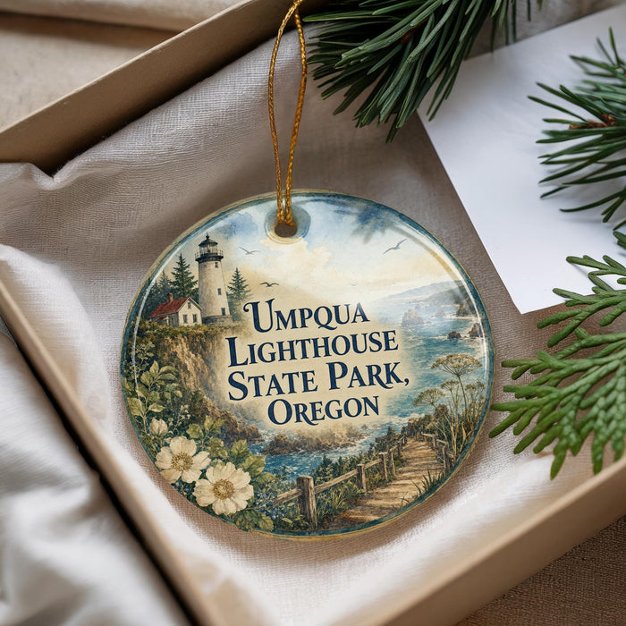 A decorative ornament with a lighthouse and a scenic landscape, featuring the text "Umpqua Lighthouse State Park, Oregon".