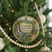 A round ornament hanging on a Christmas tree, featuring a scenic image of Underhill State Park in Vermont.