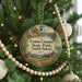 A Christmas tree ornament with a scenic landscape of Union County, South Dakota, featuring a deer and a cabin in the background.
