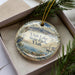 A decorative ornament in a box, featuring a scenic image of Utah Lake State Park with a bird, sailboat, and mountains in the background.