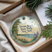 A decorative ornament with a scenic beach view, featuring a lifeguard tower, pine trees, and a body of water.