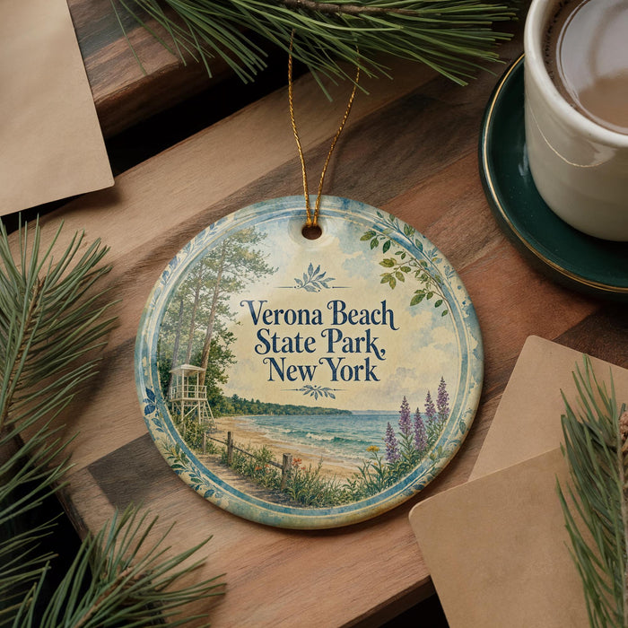A decorative ornament with the text "Verona Beach State Park New York" is displayed on a wooden surface, surrounded by pine branches and a cup of coffee.