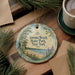 A decorative ornament with the text "Verona Beach State Park New York" is displayed on a wooden surface, surrounded by pine branches and a cup of coffee.