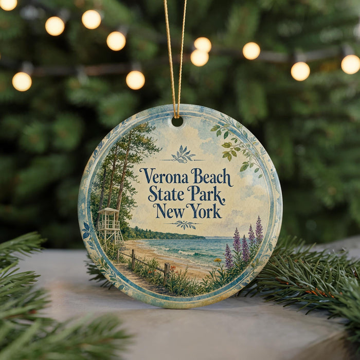 A round ornament with a beach scene and text, hanging on a string.