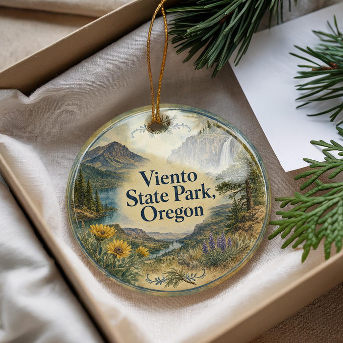 A decorative ornament with a scenic landscape of mountains, pine trees, and a waterfall, featuring the text "Viento State Park, Oregon" on it.