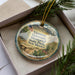 A decorative ornament in a box, featuring an illustration of a memorial and the text "Vietnam Veterans Memorial State Park New Mexico".