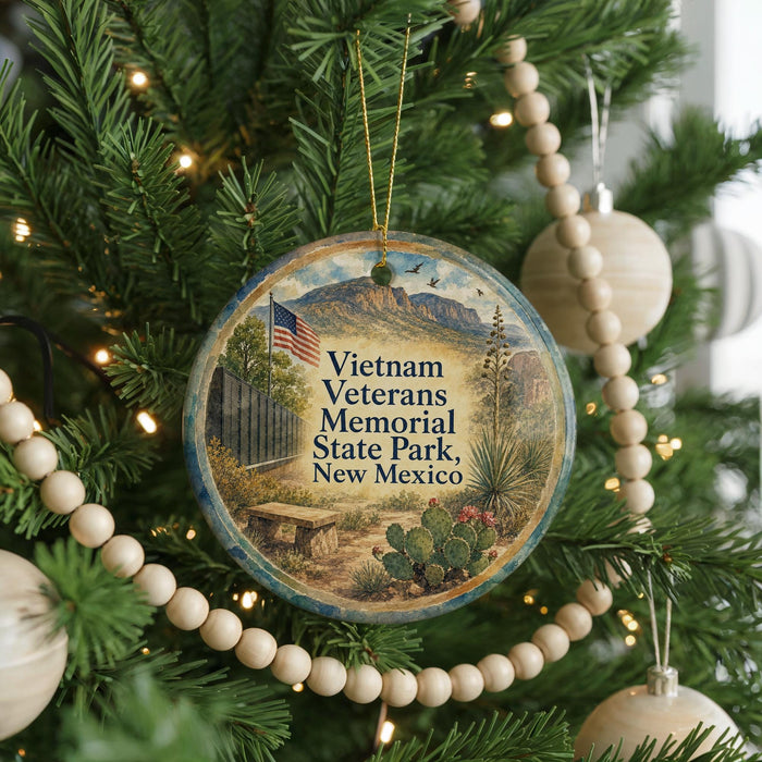 A round ornament on a Christmas tree, featuring an illustration of a memorial park and the text "Vietnam Veterans Memorial State Park, New Mexico".