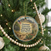A round ornament on a Christmas tree, featuring an illustration of a memorial park and the text "Vietnam Veterans Memorial State Park, New Mexico".