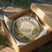 A decorative ornament in a box, featuring an image of a memorial with a Vietnamese flag and the text "Vietnam Veterans Memorial State Park, New Mexico".
