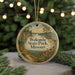 A circular ornament with a scenic landscape of Wokonda State Park, Missouri, featuring a path, flowers, and a cabin in the background, surrounded by Christmas lights.