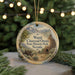 A round ornament with a scenic illustration of a historic site, featuring a chimney, trees, and mountains, hanging from a string.