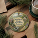 A decorative ornament featuring a scenic image of Waterbury Center Park, Vermont, with a small house and stream in the foreground.