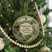 A round ornament hanging on a Christmas tree, featuring a scenic image of Waterbury Center State Park in Vermont.