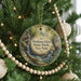 A round ornament hanging on a Christmas tree, featuring a scenic image of Watkins Glen State Park in New York.