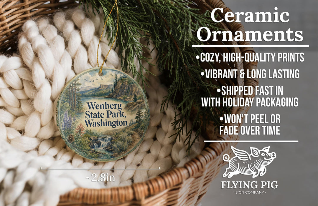 Ceramic ornaments, specifically those shaped like the Wenberg State Park in Washington, are displayed in a basket. The ornaments are described as cozy, high-quality prints, vibrant, and long-lasting, and are shipped fast in holiday packaging. They are not to be peeled or faded over time.