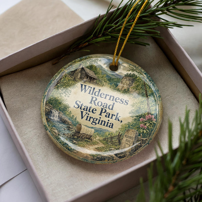 A decorative ornament in a box, featuring illustrations of a scenic road and a sign that says "Wilderness Road, Virginia".