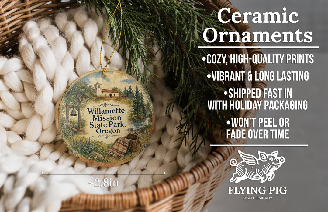 Ceramic ornaments, featuring a wooden ornament with a scene of Willamette Mission State Park, Oregon, hanging from a wicker basket.