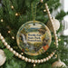 A Christmas tree decorated with ornaments, including a circular ornament with a scenic image of Pennsylvania State Park.