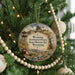 A circular ornament hanging on a Christmas tree, featuring an illustration of a historic prison and the text "Wyoming Territorial Prison State Historic Site Wyoming".